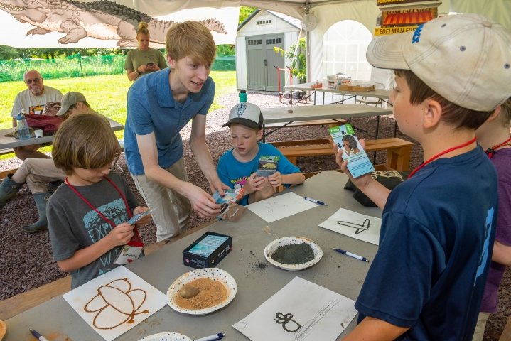 Undergrad Lucas Petrin explains his game to campers at Rowan's Fossil Park.