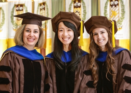 Three Ph.D. graduates in pharmaceutical chemistry at their commencement ceremony.