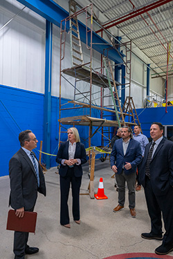 Rowan leaders tour a practice construction site with bare drywall at the Finishing Trades Institute.