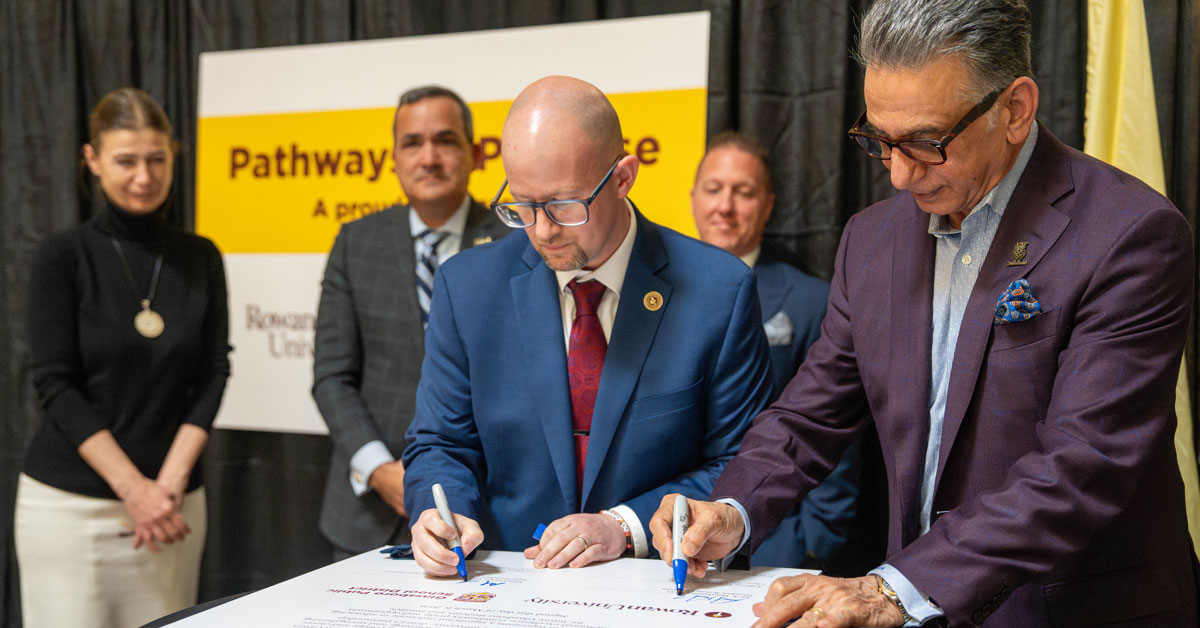 Dr. Al Lewis and Dr. Ali Houshmand sign the agreement establishing a formal partnership between Glassboro Public Schools and Rowan University.