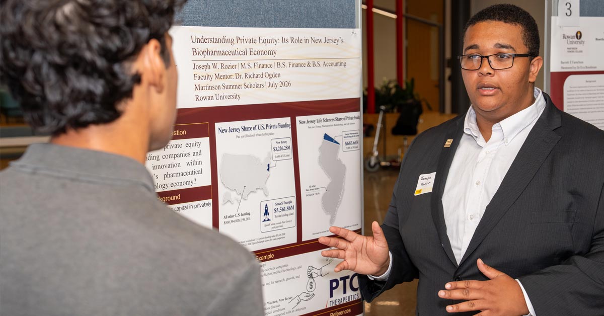 Student Joseph Rozier presents his research at a poster session with other students from the Martinson Honors College.
