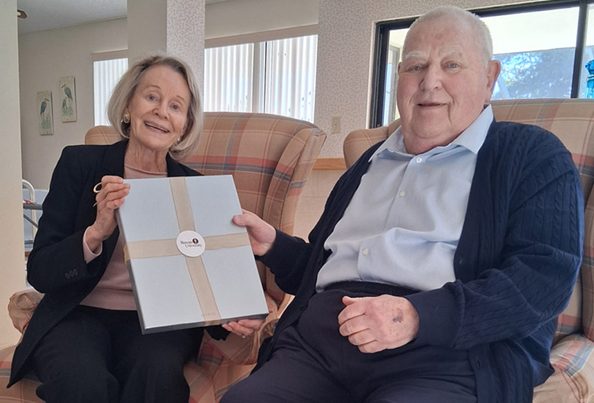 Virgina Rowan Smith presents a certificate to John Mortimer.
